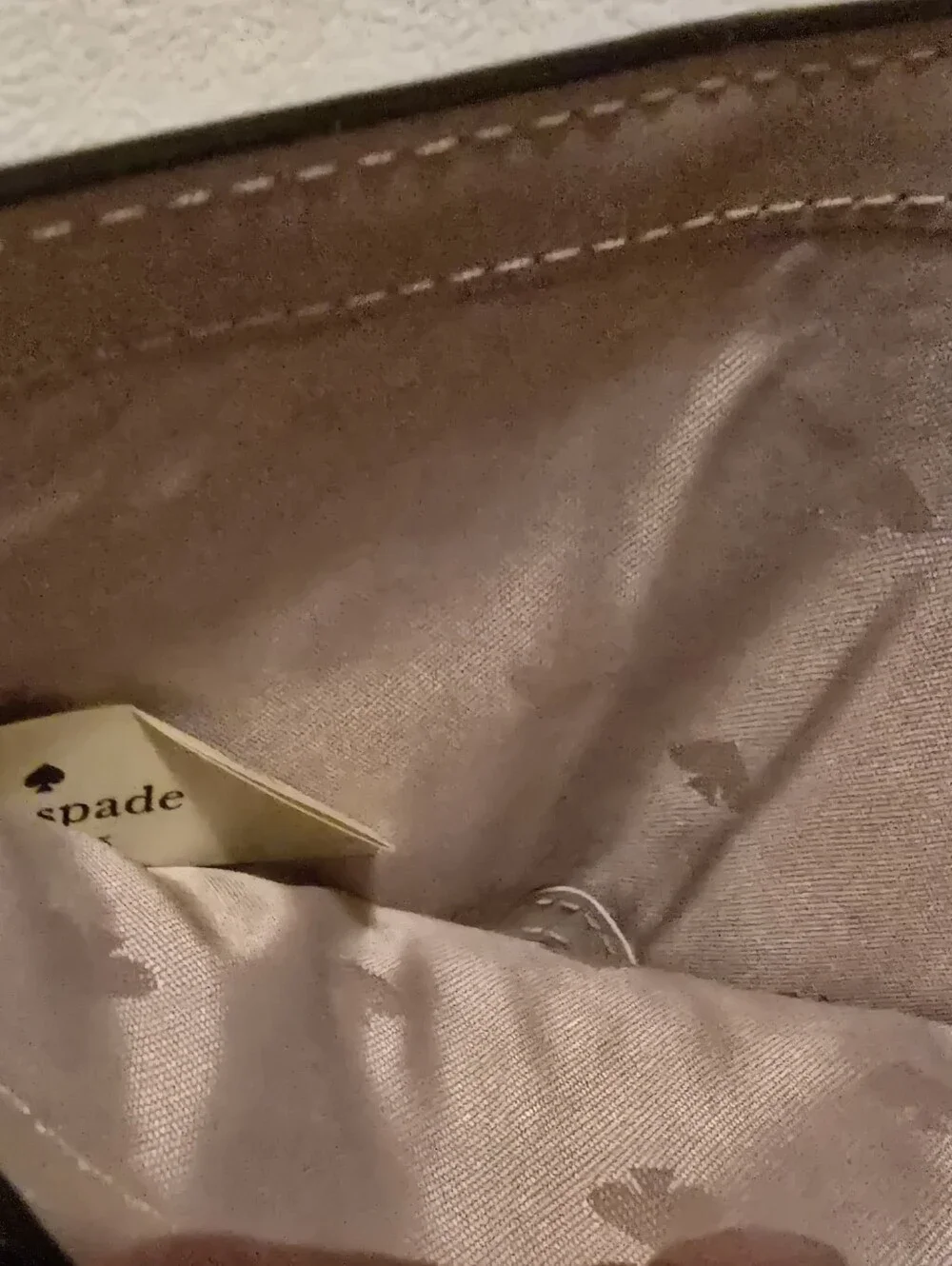 Kate Spade New York Staci small zip-around bifold wallet featuring a glittery ro